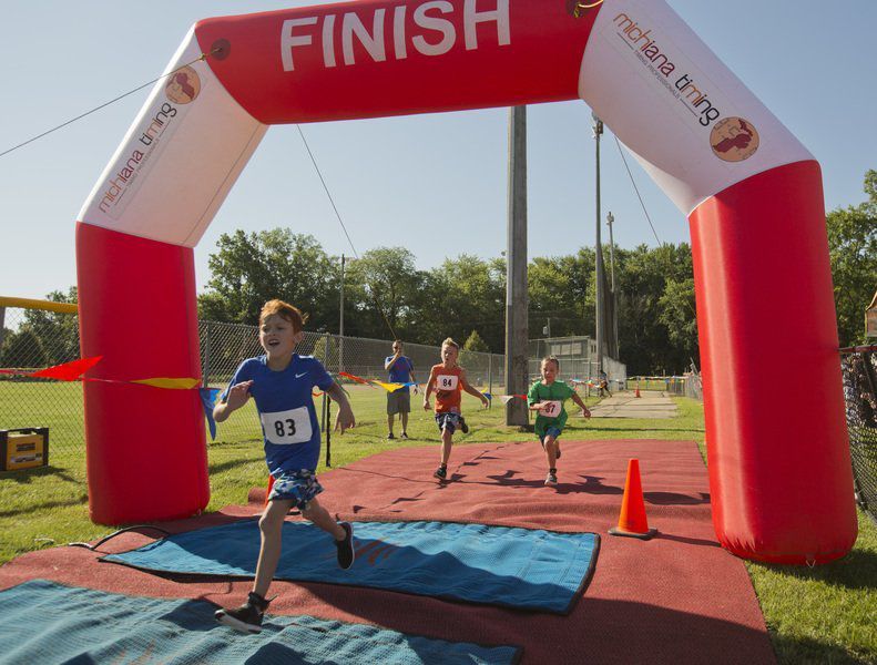 Child running through finish line.