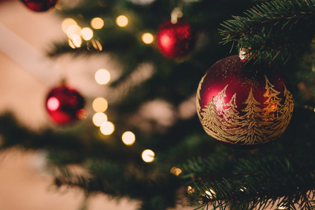 Up close photo of pine tree with lights and ornaments