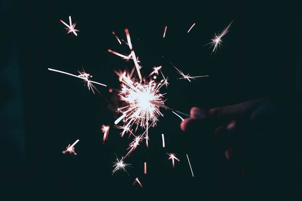 A hand holding a sparkler